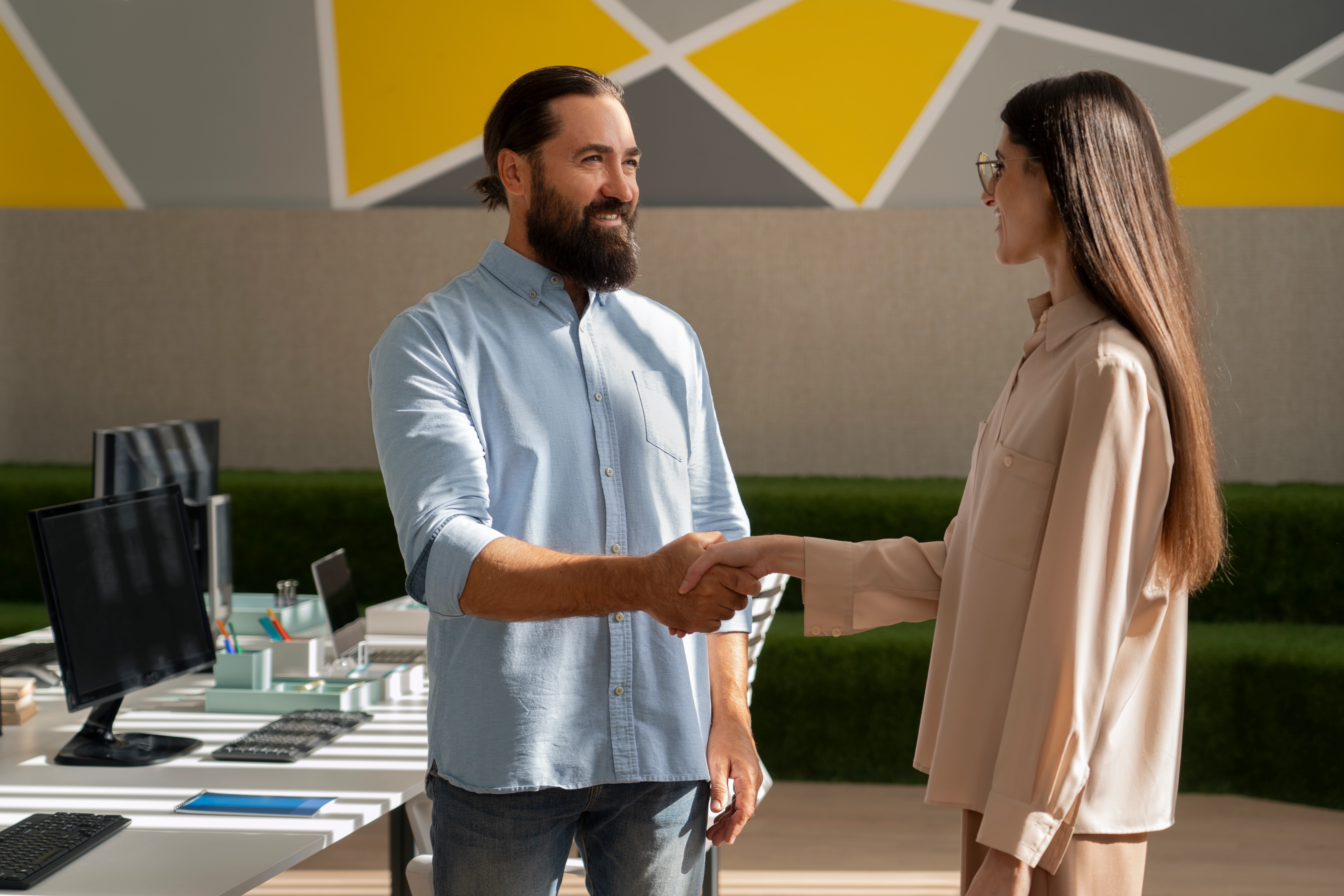 Business man and customer showcasing trust. Business professional and customer shaking hands in a modern office.